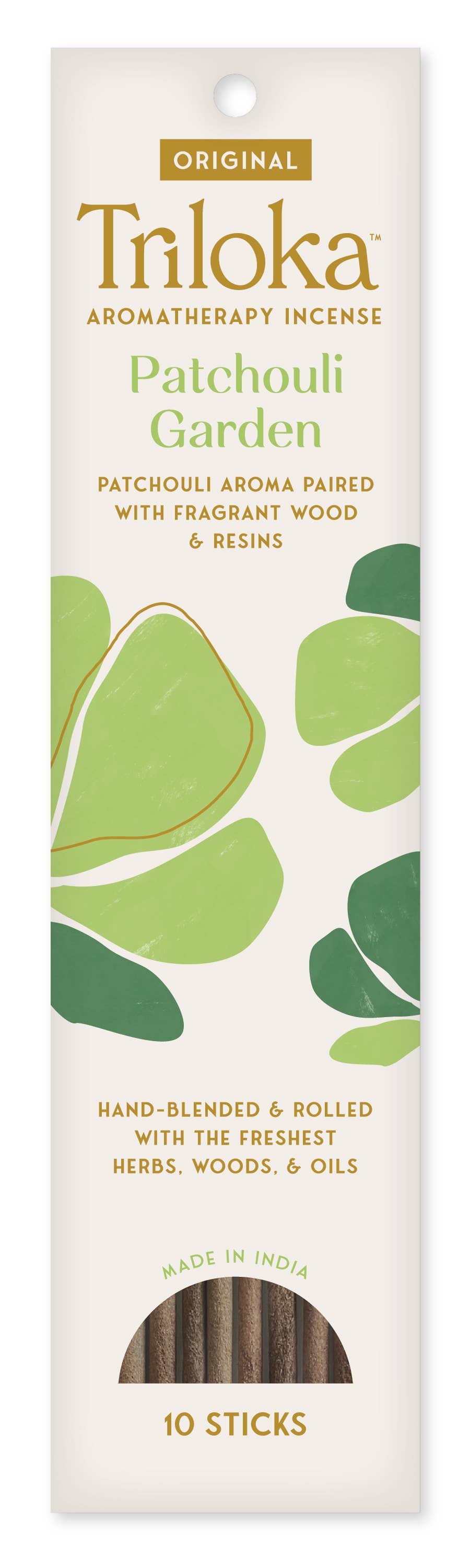 Triloka Patchouli Garden aromatherapy incense packaging with green leaves on a white background