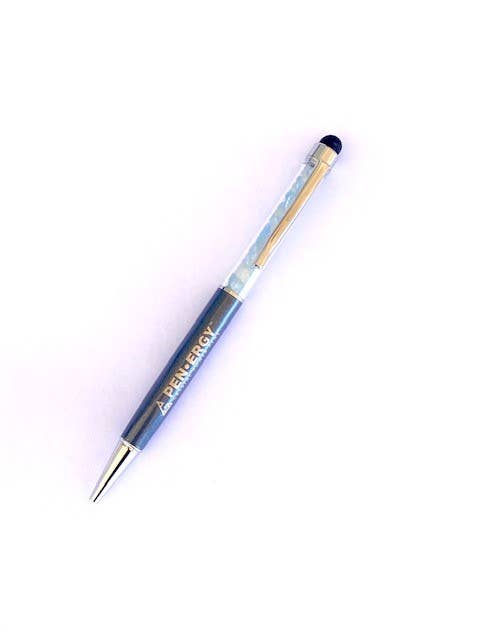 A pen-ergy ballpoint pen with a dark blue barrel, a clear textured grip, gold-toned metal accents, and a black tip, shown on a plain white background.